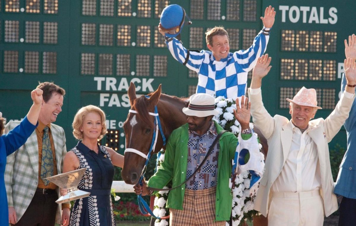 The movie gang celebrates the Belmont Stakes with a real Triple Crown trophy. (Disney photo)