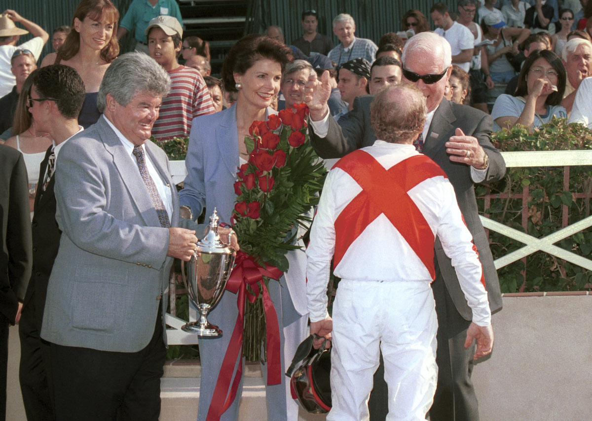 Eduardo Inda (left) and Aaron Jones greet Chris McCarron after one of his half-dozen stakes wins with Riboletta. Photo: Benoit