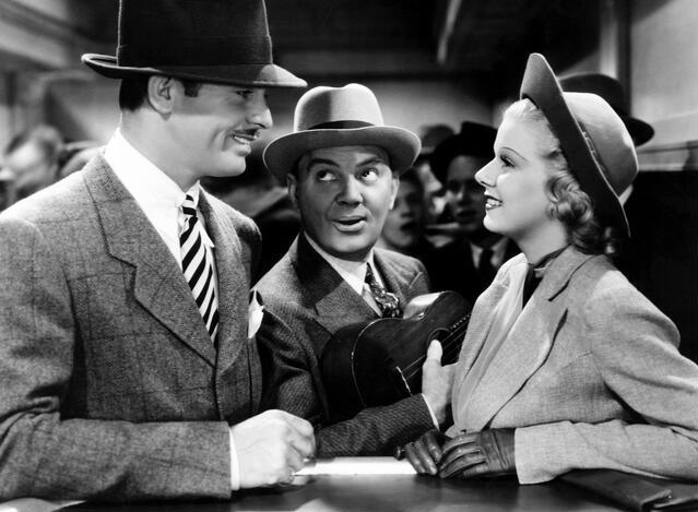 Cliff Edwards, a tout named Tip, lurks as Gable and Harlow try to out-scam each other. (MGM photo)