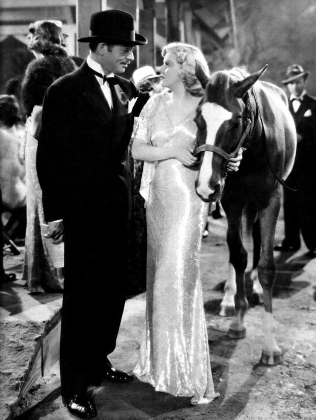 Clark Gable and Jean Harlow know how to show off a young Thoroughbred at a horse sale. (MGM photo)