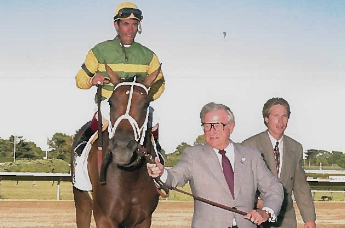 Bob Lewis leads Serena's Song and Stevens into the Haskell winner's circle, accompanied by assistant trainer Dallas Stewart. (Monmouth Park photo)