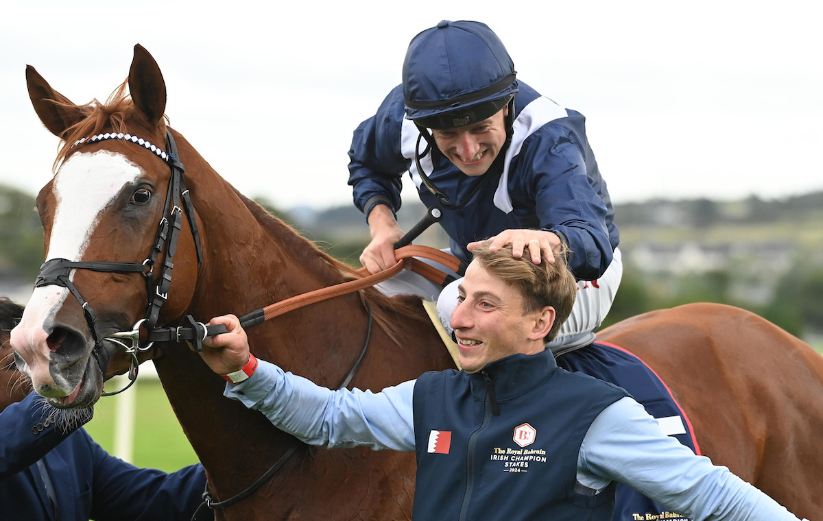 Job done: Tom Marquand and Economics with groom Ricky Hall after winning the Irish Champion Stakes. Photo: Healy Racing / focusonracing.com