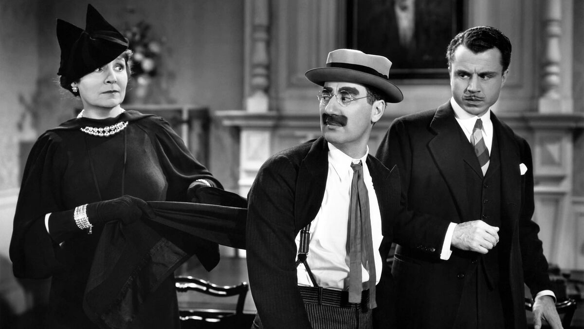 Flanked by Margaret Dumont and Leonard Ceeley, Groucho is in full survival mode as the phony Dr. Hackenbush. (MGM Studio photo)