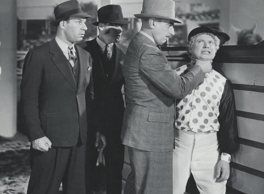 After failing to throw a race jockey Harpo angers the crooked owner. (MGM Studio photo)