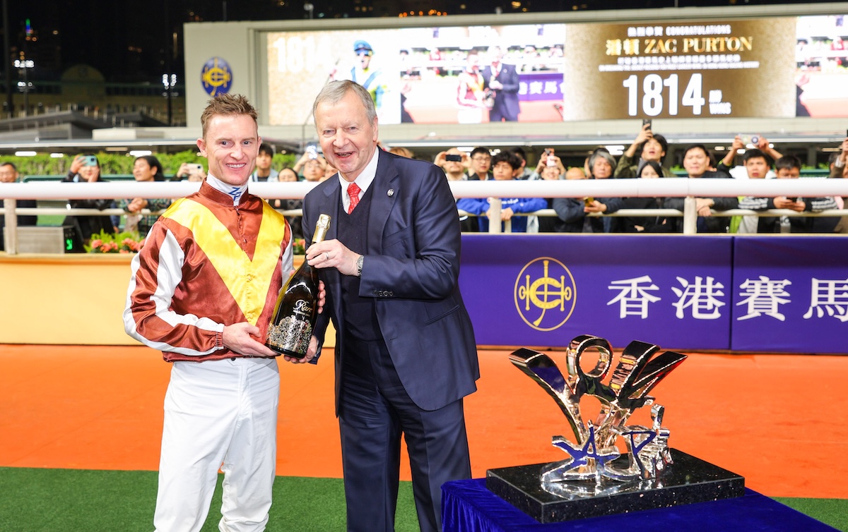 Zac Purton and Winfried Engelbrecht-Bresges, HKJC CEO, commemorate the milestone win. Photo: HKJC